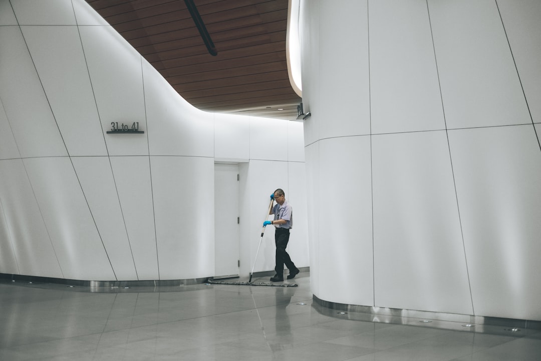 about-01 man-cleaning-on-floor-beside-white-wall-mww-zrkysiu